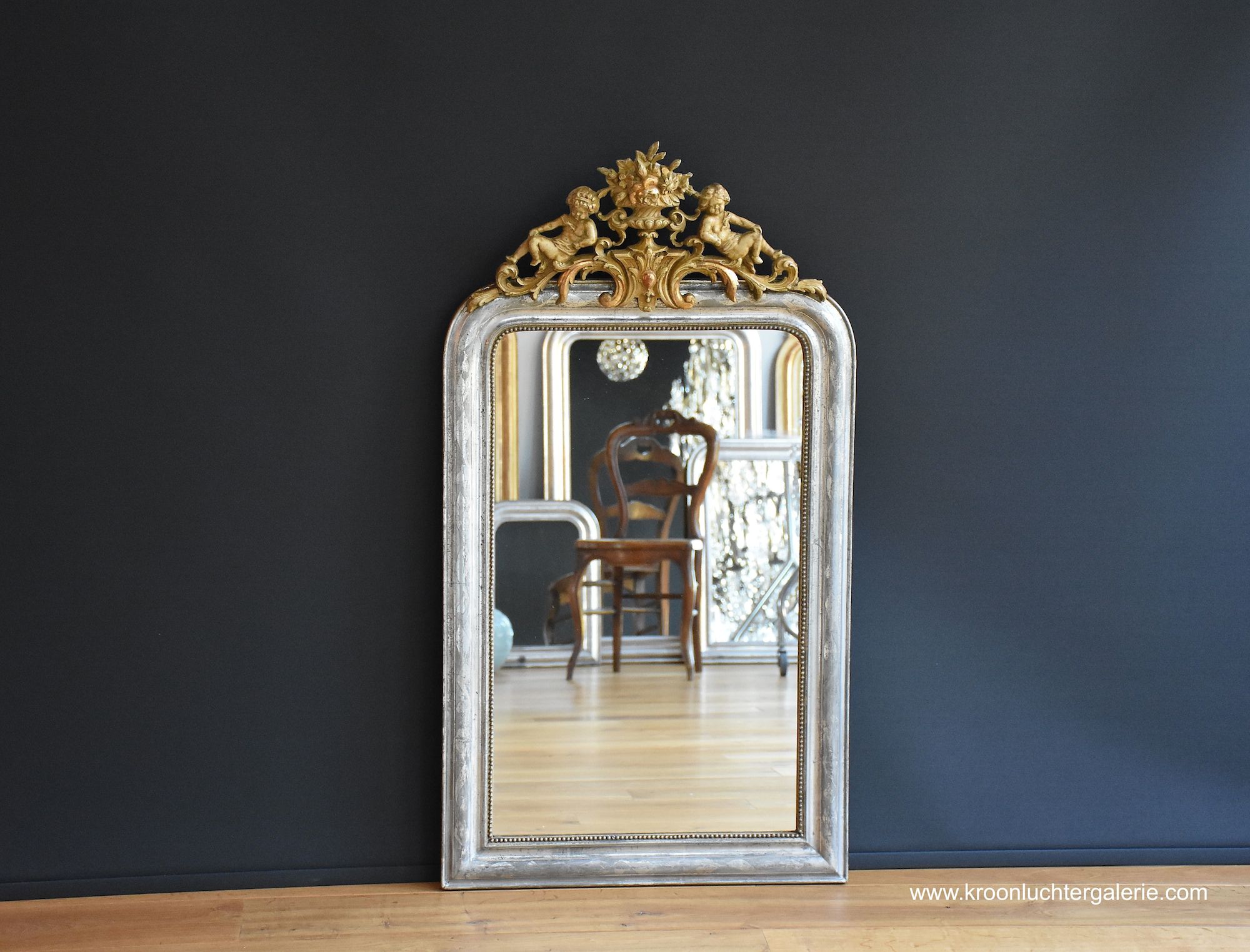 Silvered French mirror with a crest