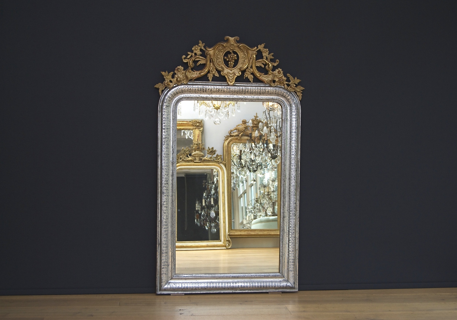 A beautiful antique French silvered mirror with a crest