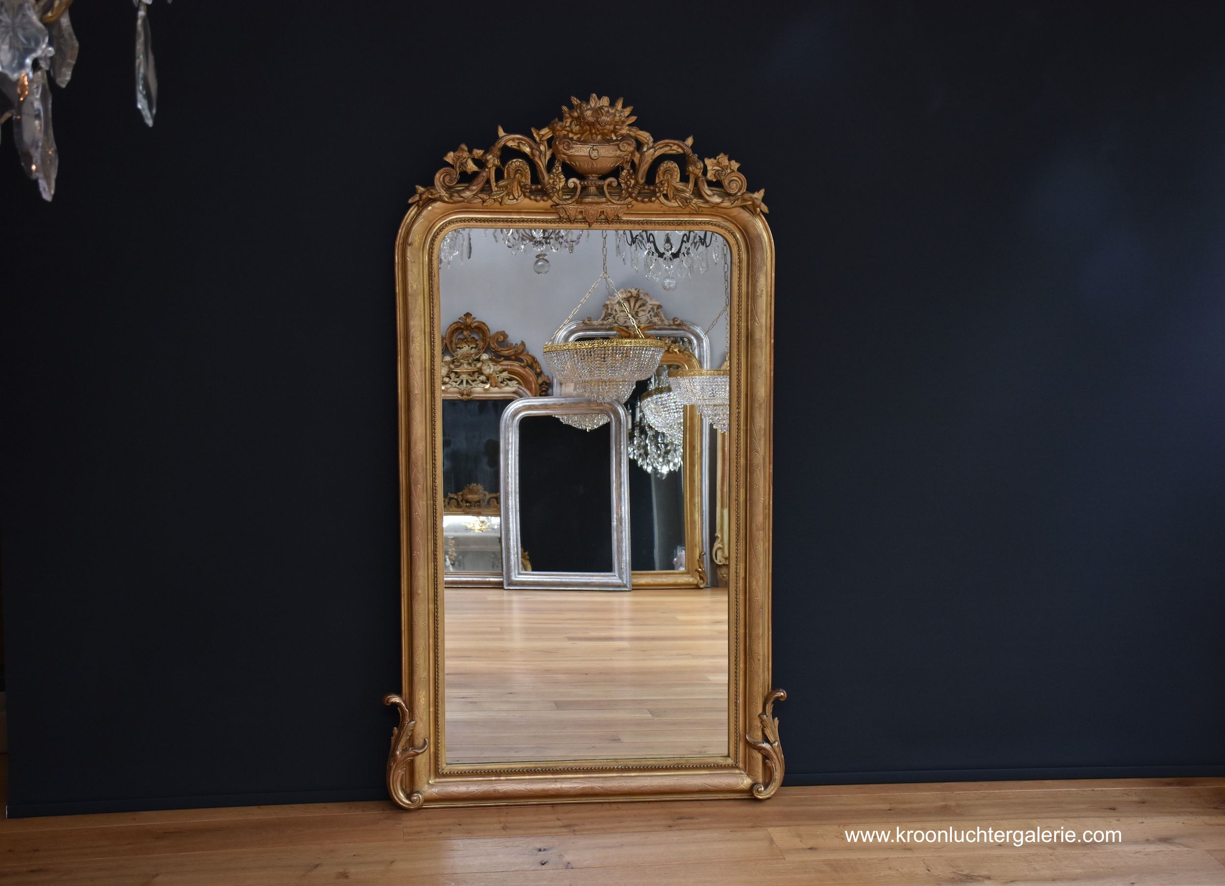 Antique French mirror with a crest, gold-leaf