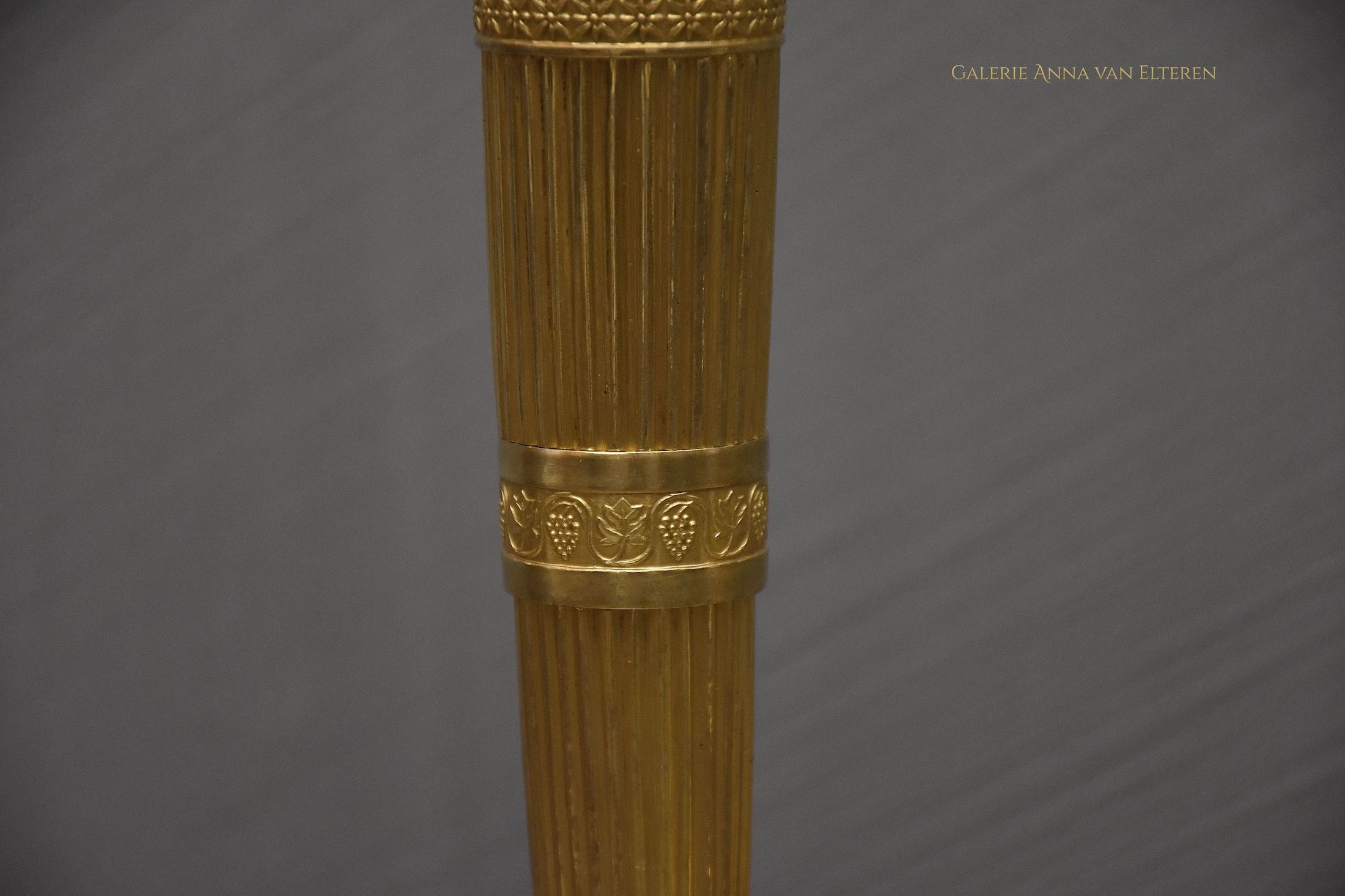A pair of French Empire ormolu candlesticks